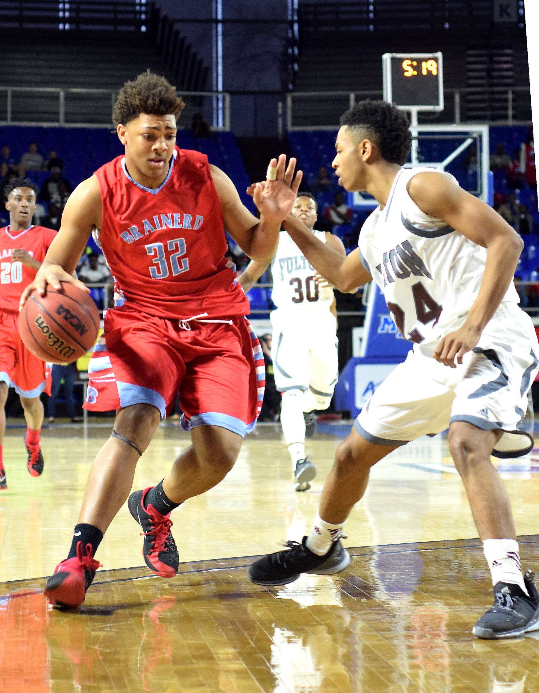 Brainerd's Jesse Walker (32) tries to drive past Fulton's Ron Davis III (24). The Brainerd High Panthers faced the Fulton High Falcons in the TSSAA State Division I Class AA Championship at the Murphy Center on the campus of Middle Tennessee State University in Murfreesboro March 19, 2016.