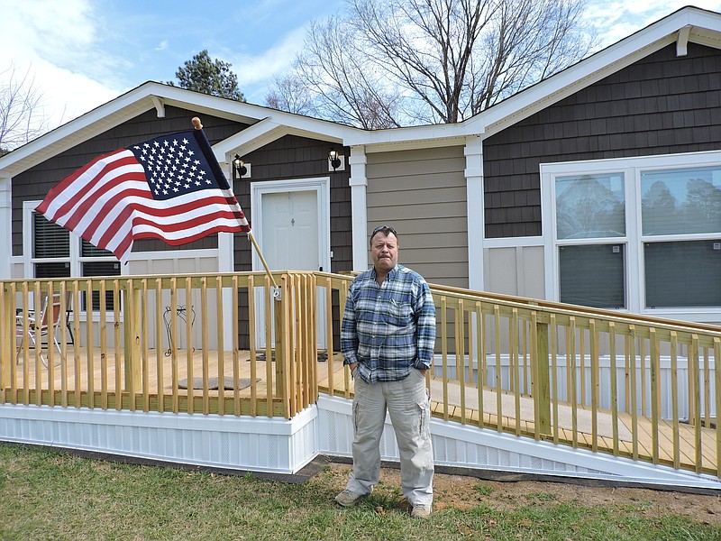 Mountain View Estates owner David A. Roden stands in front of one of the new homes in his subdivision in the north end of Walker County. He hopes the county will clean up some of the dilapidated properties around his subdivision.