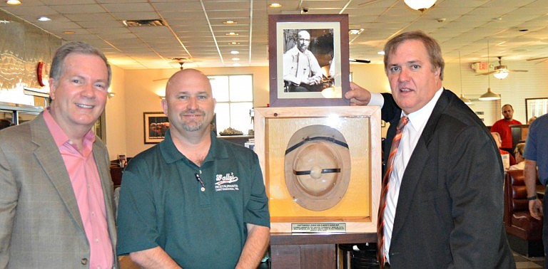 David Carroll, Wally's owner Gary Meadows and Alan Pressley stand near the display honoring Bob Elmore that now hangs in the McCallie Road restaurant. Luther Masingill's hat hangs at the East Ridge location.