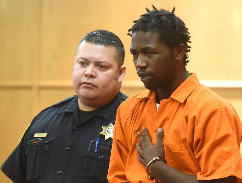 Dominique Cal is led by courtroom officer Luis Cavazos Tuesday, March 22, 2016 into Judge Lila Statom's courtroom at the Hamilton County-Chattanooga Courts Building.