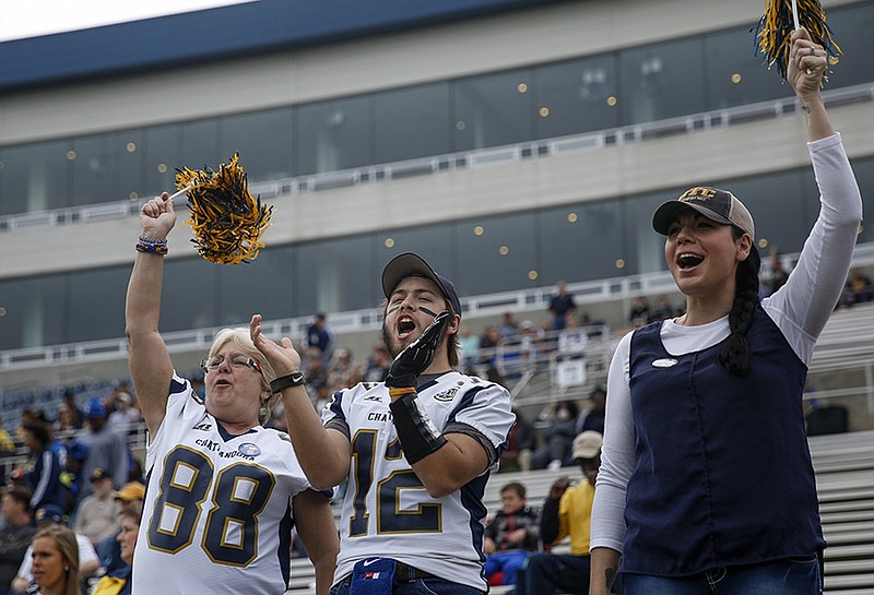 Staff file photo by Doug Strickland / Fans Judy Bonine, Kyle Adkins, and Jennifer Roche, from left, cheer before the Mocs' FCS playoff football game against Fordham at Finley Stadium on Nov. 28, 2015.