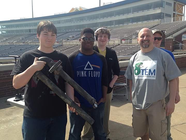 STEM School principal Dr. Tony Donen is pictured with several students and Jubilee attendees showing off one of the favorites at last year's event: a rocket launcher the students made that could send projectiles flying for about 30 yards.