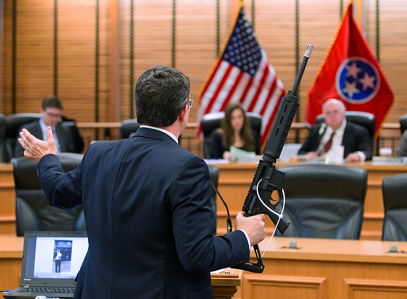 State Rep. Mike Stewart, D-Nashville, shows a gun he bought without a background check to the House Civil Justice subcommittee in Nashville, Tenn., on Wednesday, March 23, 2016. The committee later defeated Stewarts bill seeking to require background checks for all gun purchases in Tennessee. (AP Photo/Erik Schelzig)