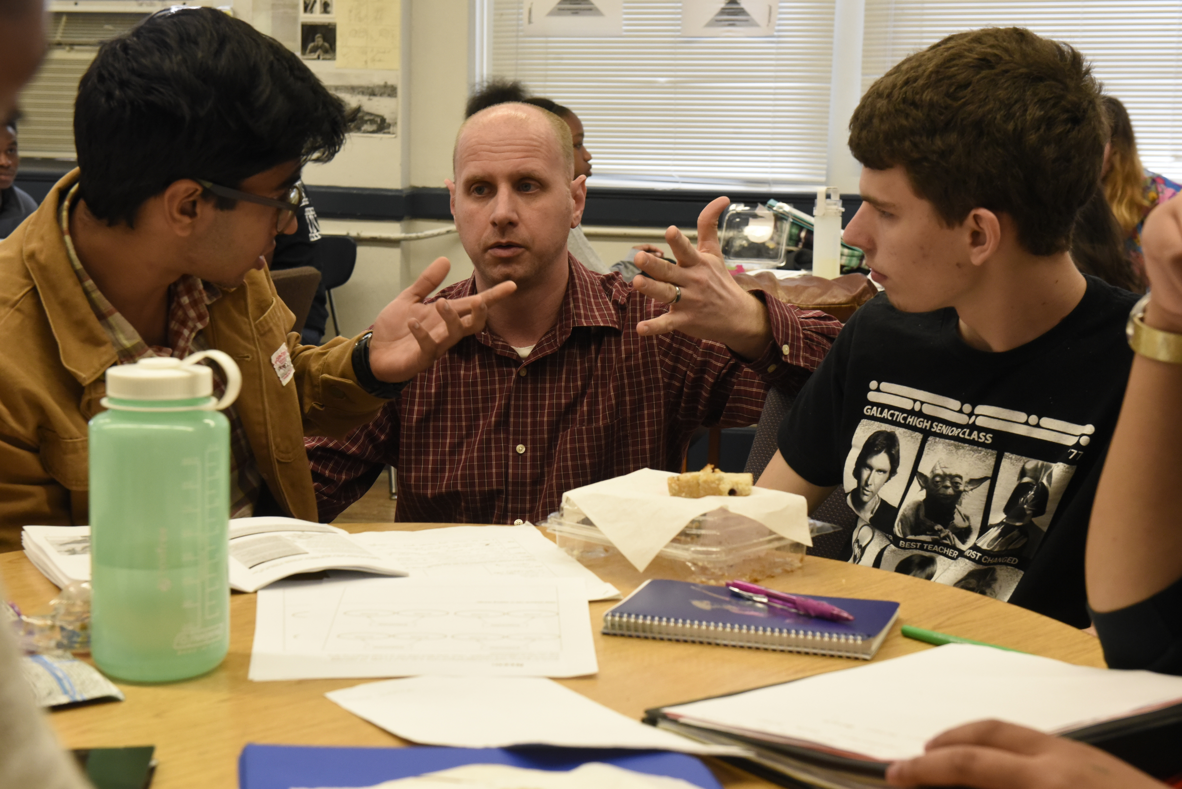 Teacher Kevin Aslinger talks with 11th grade students Parth Doshi, left, and Aaron Slack, right, as Chattanooga School for the Arts and Sciences students discuss Chattanooga 2.0 during their 11th grade seminar class Wednesday, Mar. 23, 2016, in Chattanooga, Tenn.