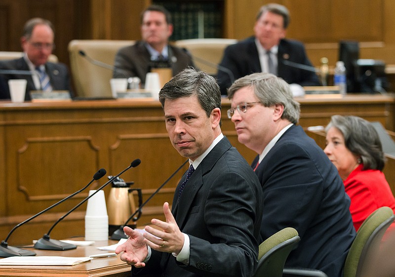 Chattanooga Mayor Andy Berke, left, signals to an aide during a Senate committee hearing about a de-annexation bill in Nashville on Wednesday, March 23, 2016. At right are Memphis Mayor Jim Strickland and Knoxville Mayor Madeline Rogero, who also oppose the bill that could wind up shrinking the size of several Tennessee cities.