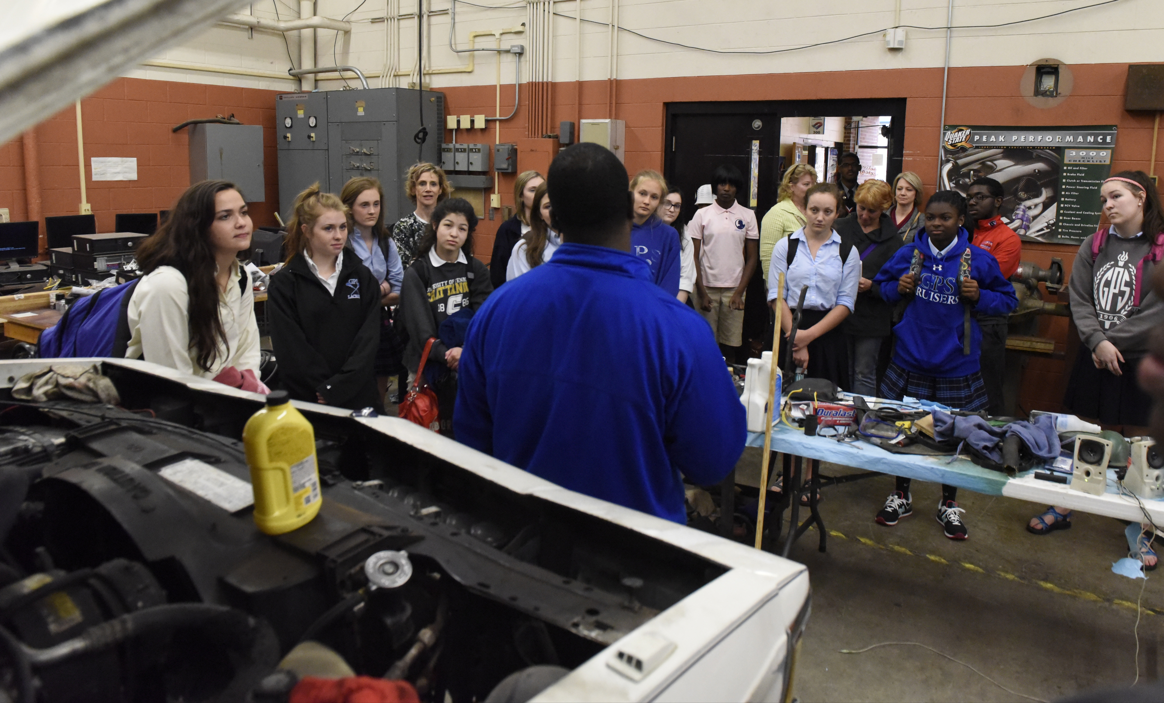 Students from a social justice class at the Girls Preparatory School drop in on instructor David Moore's automotive technology classroom as they visit Brainerd High School on Thursday, Mar. 24, 2016, in Chattanooga, Tenn.