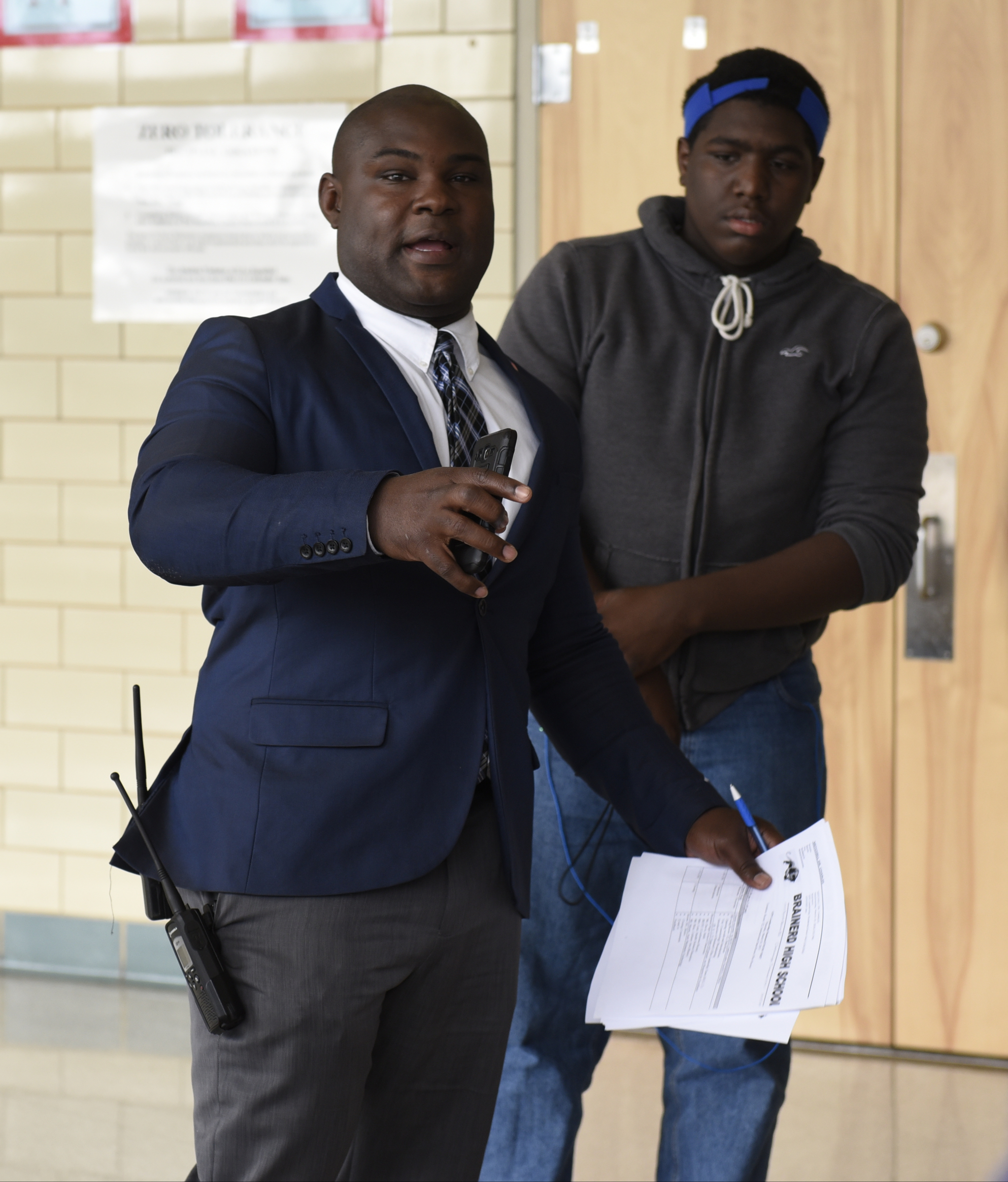 Dr. Charles Mitchell greets guests as students from a social justice class at the Girls Preparatory School visit Brainerd High School on Thursday, Mar. 24, 2016, in Chattanooga, Tenn. At right is Elijah Locklin, making photographs for the school yearbook.