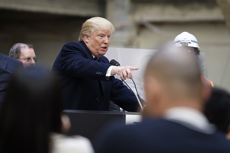 Republican presidential candidate Donald Trump points to a reporter during a campaign event in the atrium of the Old Post Office Pavilion on Monday.