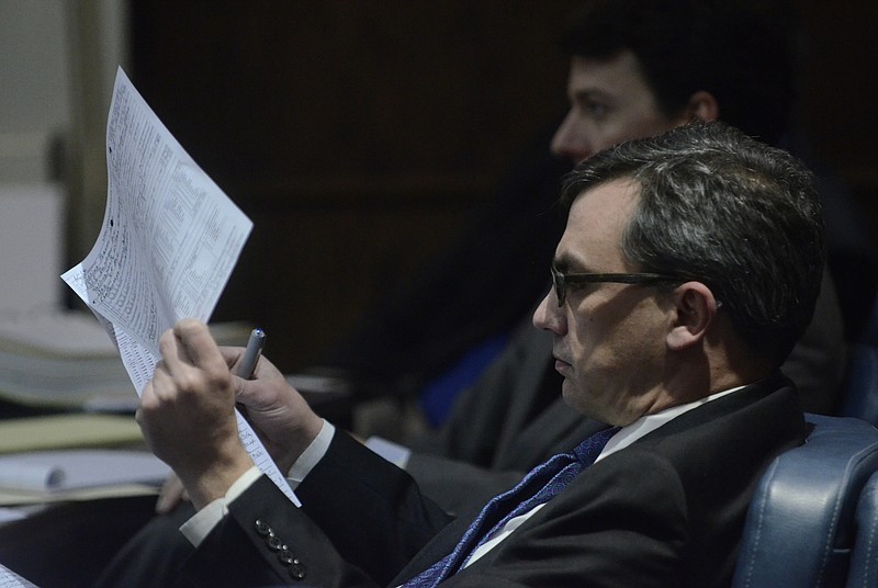 Prosecutor Neal Pinkston reads during the first day of a trial for Adolphus Hollingsworth, who is charged in the 1997 murder of his wife, Victoria Witherspoon Carr.