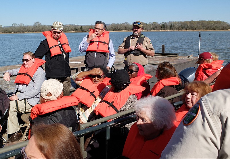 Cherokee Nation Supreme Court Justice Troy Wayne Poteete, local businessman Greg Vital and TWRA Game Warden, Jason Jackson, standing left to right, ready a tour group for departure to Jolly's Island recently. The island is considered one of the best Native American archaeological sites in the country.