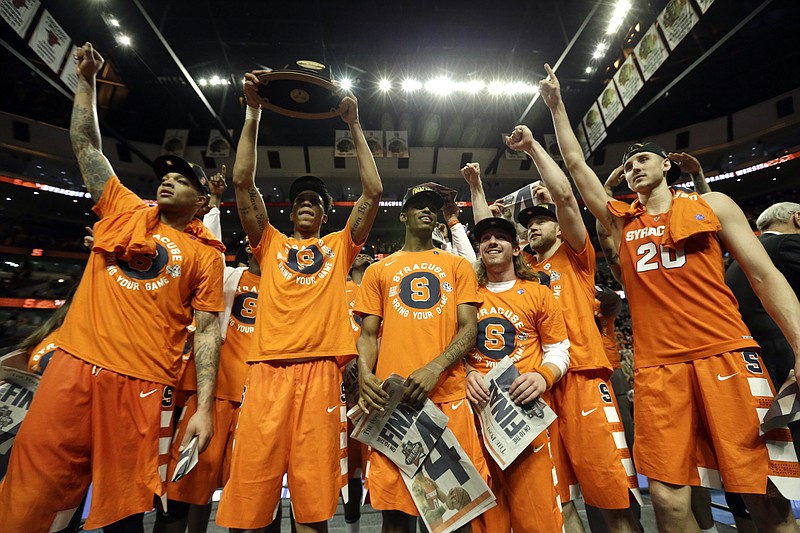 Syracuse players celebrate after an NCAA college basketball game against Virginia in the regional finals of the NCAA Tournament, Sunday, March 27, 2016, in Chicago. Syracuse won 68-62. (AP Photo/Nam Y. Huh)