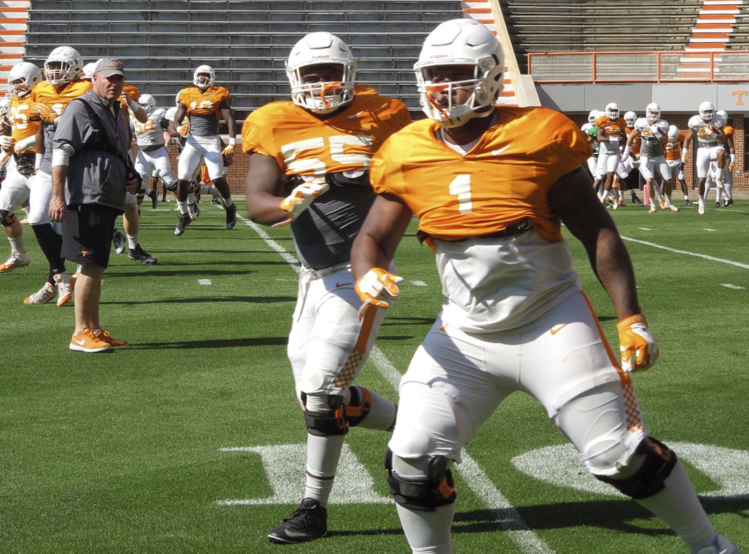Tennessee defensive line coach Steve Stripling, back left, watches Quay Picou (55) and Kahlil McKenzie during a drill during a recent spring practice. Several of Stripling's young players are getting plenty of time during spring practice because of injuries.