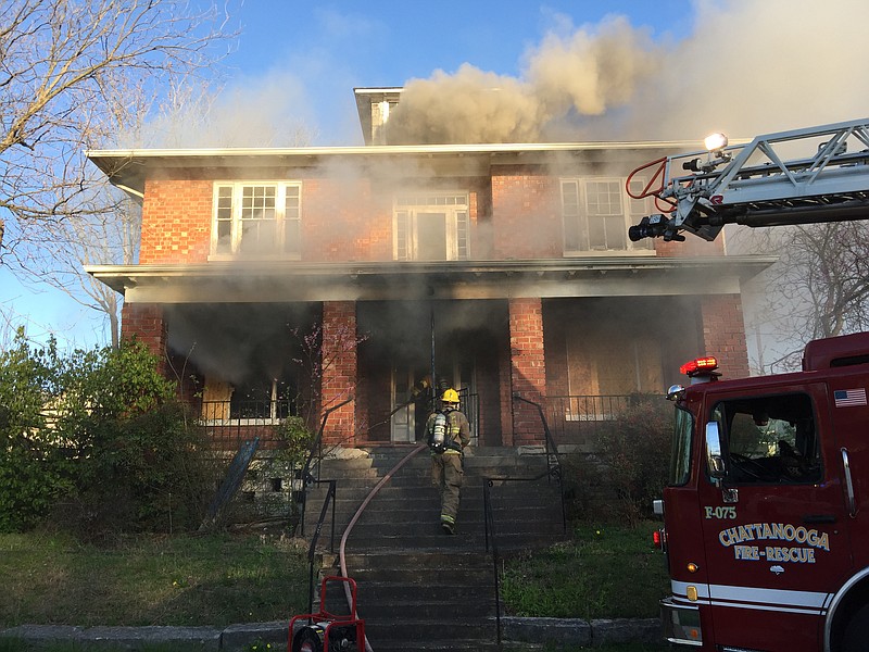 Firefighters work to put out a blaze Monday evening at a vacant home on South Willow Street.