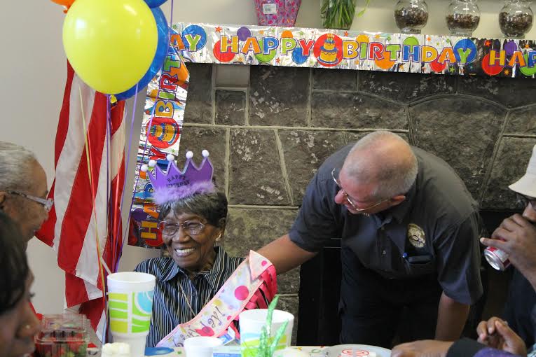 Chickamauga Police Detective Ira Taylor, right, congratulates Chickamauga's Jerrel Dean Hudgins at her 100th birthday party at the Chickamauga Active Living Center. Her church, Mountain View Church of Christ, had a party for her too.