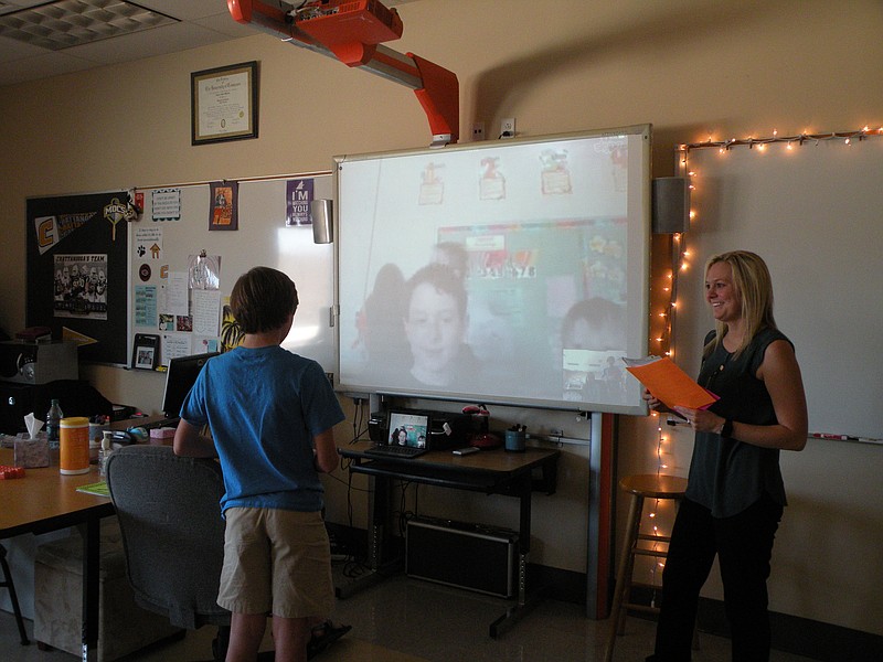 During a recent Mystery Skype session, Kaid Boehm asks students in a Canadian classroom questions to help his Signal Mountain Middle School Computer Technology and Design class be the first to guess the other school's location as teacher Hayley Wood looks on.