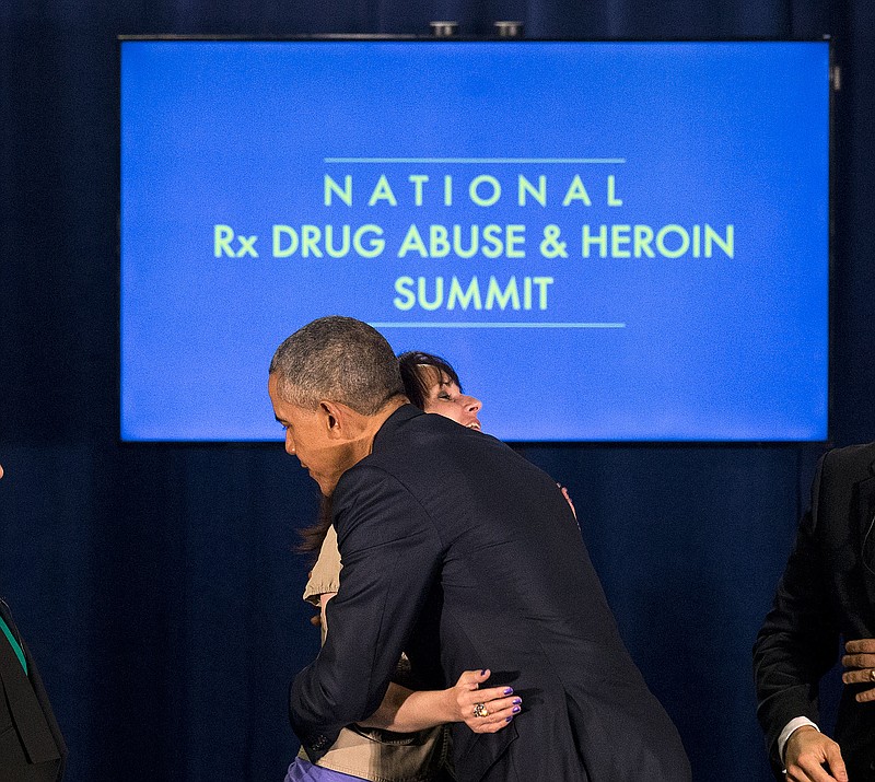 
              President Barack Obama hugs Crystal Oertle after a panel discussion at the National Rx Drug Abuse and Heroin Summit Tuesday, March 29, 2016, in Atlanta. Oertle spoke about her struggle with prescription drug addiction. (AP Photo/John Bazemore)
            