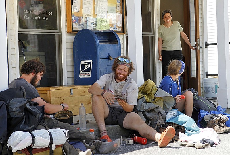 Appalachian Trail hikers eat lunch outside of a post office in Caratunk, Maine. Hikers depend on resupply packages to help them make the long trek from Georgia to Maine (or vice versa).