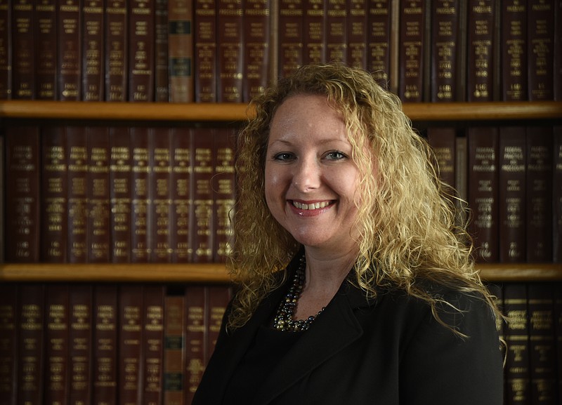 Family law attorney Corrin Fulton stands in the library of Geahiser, Peters, Elliott & Cannon, PLLC, Friday, March 4, 2016.