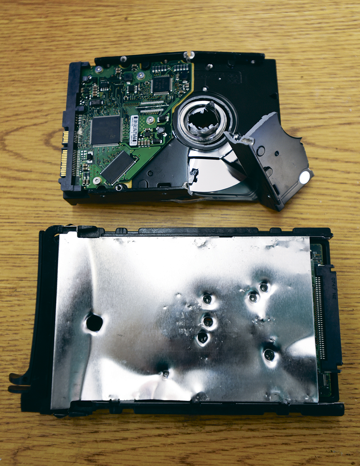 Two hard drives, one with a hole punched through it, and one with bullet holes, would still contain retrievable data.