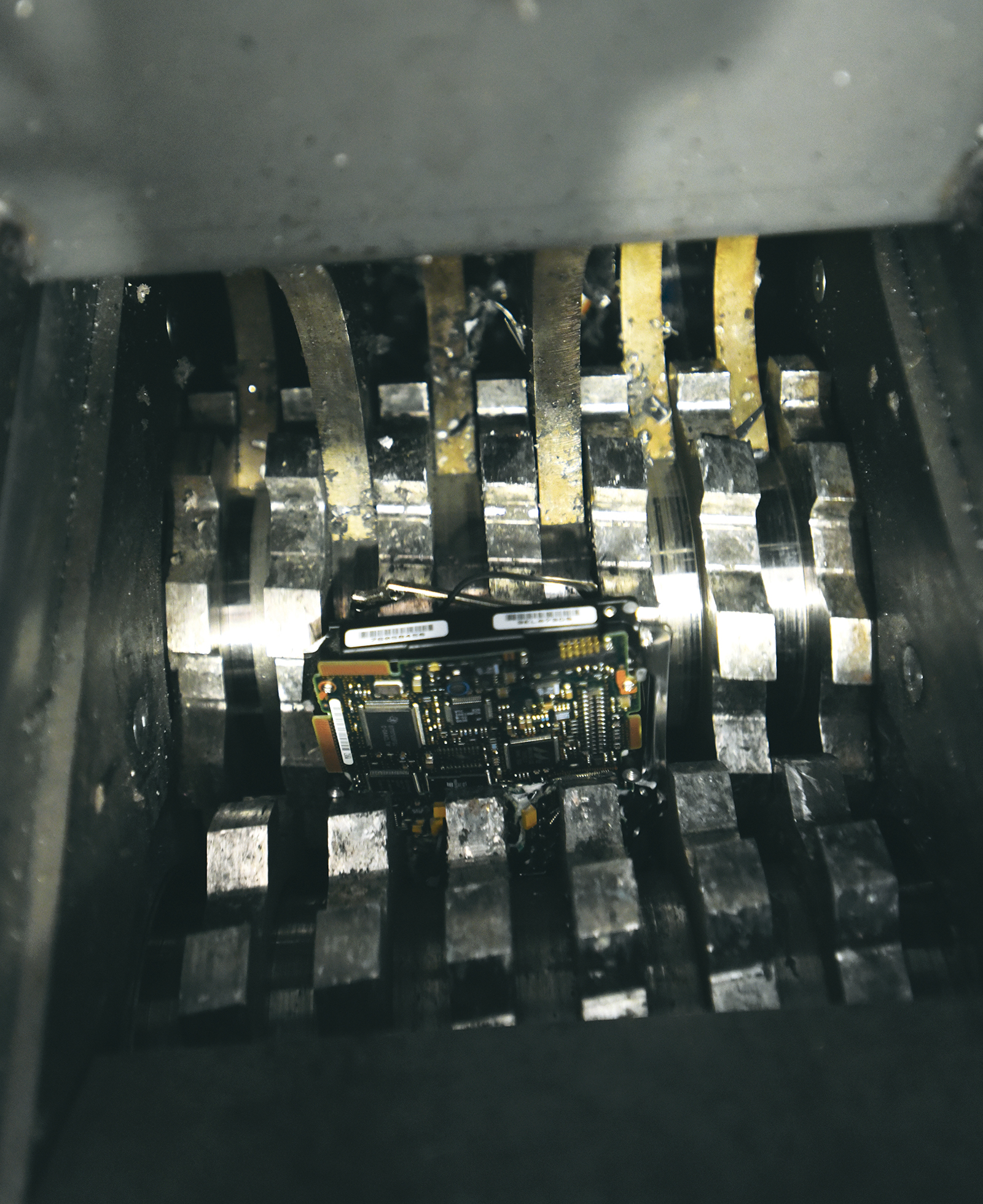 A hard drive falls into the shredder at Resource 1.