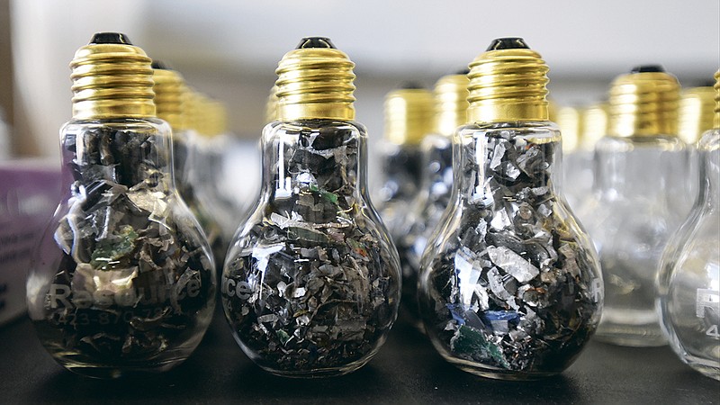 Hard drive bits are packaged into light bulbs as marketing material for Resource 1 Electronics.
