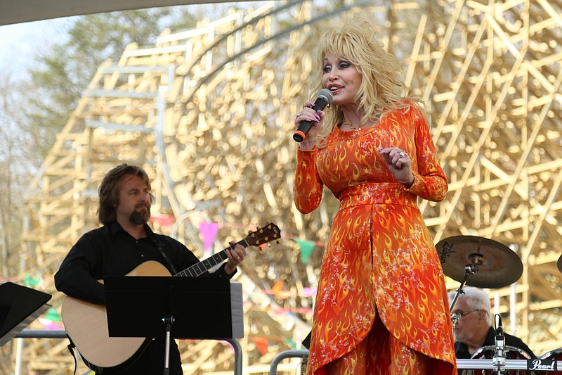 Dolly Parton takes the stage last week at Dollywood in Pigeon Forge, Tenn., to sing, to talk about the release of her new album, "Pure and Simple," and to announce her first major tour of the U.S. in 25 years. Behind her is Lightning Rod, the new woo0den rollercoast at Dollywood.