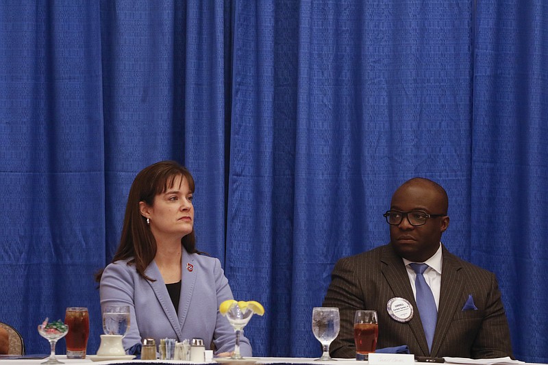 Staff Photo by Dan Henry / The Chattanooga Times Free Press- 3/31/16. Tennessee Education Commissioner Candice McQueen sits with Corderl Carter II before speaks to the Chattanooga Rotary about TN Ready during a luncheon at the Chattanooga Convention Center on Thursday, March 31, 2016. 