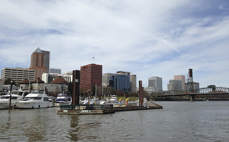 
              This March 18, 2016 photo shows the Willamette River and skyline in the background in Portland, Ore. Fiercely protective of its reputation as one of the most eco-friendly cities in the country, Portland is reeling from the discovery of poisonous heavy metals in the air and the ground of neighborhoods where thousands of people live, work and attend school. (AP Photo/Terrence Petty)
            