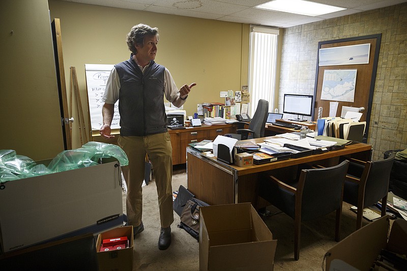 Tim Kelly talks in his office, which was being packed up for renovations at the Kelly Subaru dealership in downtown Chattanooga in this recent file photo.