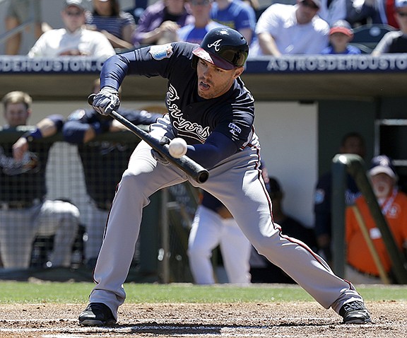 Atlanta Braves' Freddie Freeman attempts a bunt against the Houston Astros in the first inning of spring training baseball game, Tuesday, March 22, 2016, in Kissimmee, Fla. (AP Photo/John Raoux)