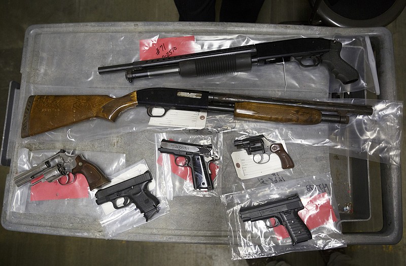 Seized firearms are displayed on a cart in the lobby of the property evidence room at the Police Services Center on Wednesday, Oct. 28, 2015, in Chattanooga, Tenn. The Chattanooga Police have seized an unusually large number of guns in only a few weeks.