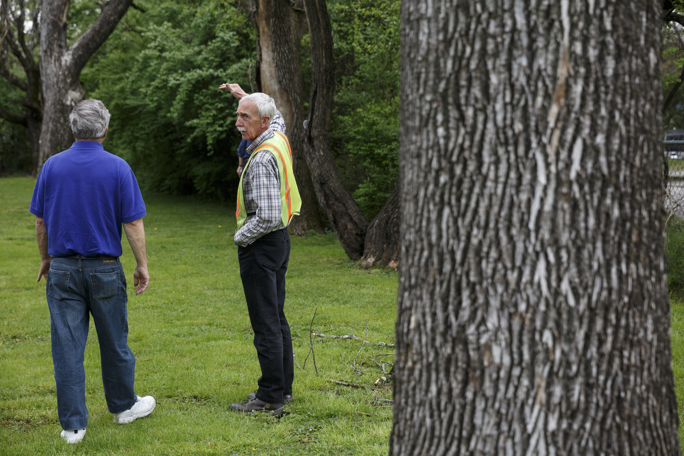 City forester Gene Hyde, right, talks about the emerald ash borer with Jimmy Voyles, who has three ash trees infested by the insect, outside his home Friday, April 1, 2016, in Chattanooga, Tenn. The invasive species is threatening the region's estimated 200,000 ash trees.