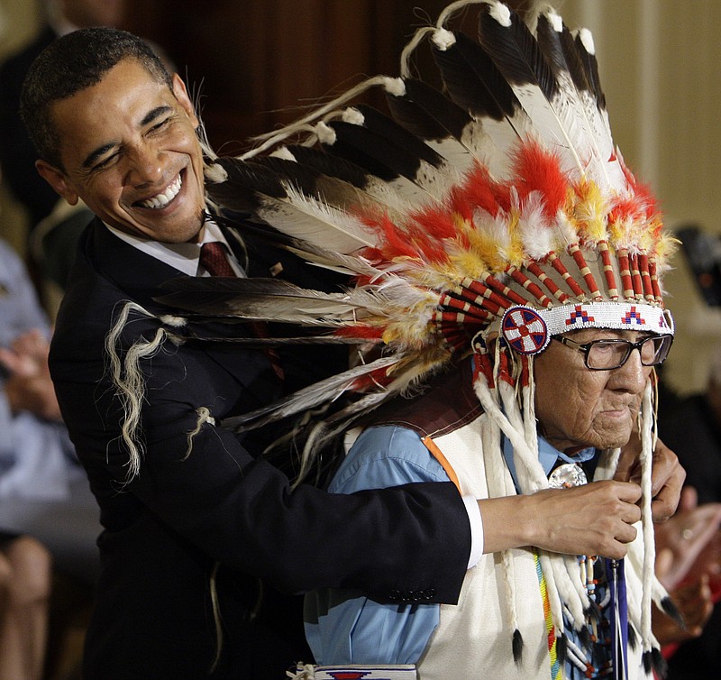 
              FILE - In this Aug. 12, 2009 file photo, President Barack Obama reaches around the head dress of Chief Joseph Medicine Crow to place a 2009 Presidential Medal of Freedom around his neck during a ceremony in the East Room of the White House in Washington. Acclaimed Native American historian Joseph Medicine Crow died Sunday, April 3, 2016, in a hospice at 102 years old. He grew up hearing stories from direct participants in the Battle of Little Bighorn. He later became his tribeï's last surviving war chief. (AP Photo/Alex Brandon, File)
            