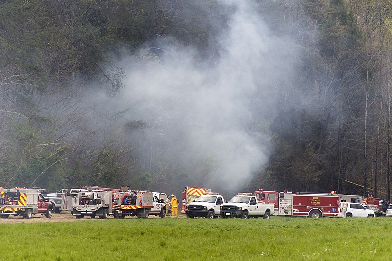 Emergency vehicles respond to the scene of a fatal helicopter crash, Monday, April 4, 2016, in Pigeon Forge, Tenn. A sightseeing helicopter crashed near the Great Smoky Mountains National Park in eastern Tennessee, officials said.