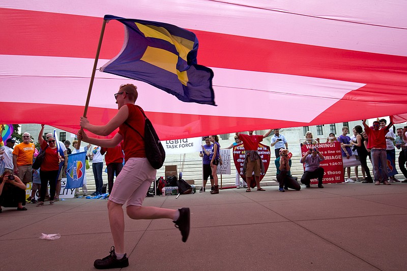 A supporter of same-sex marriage runs with an "equality" flag outside of the Supreme Court in Washington before the court declared that same-sex couples have a right to marry last summer.