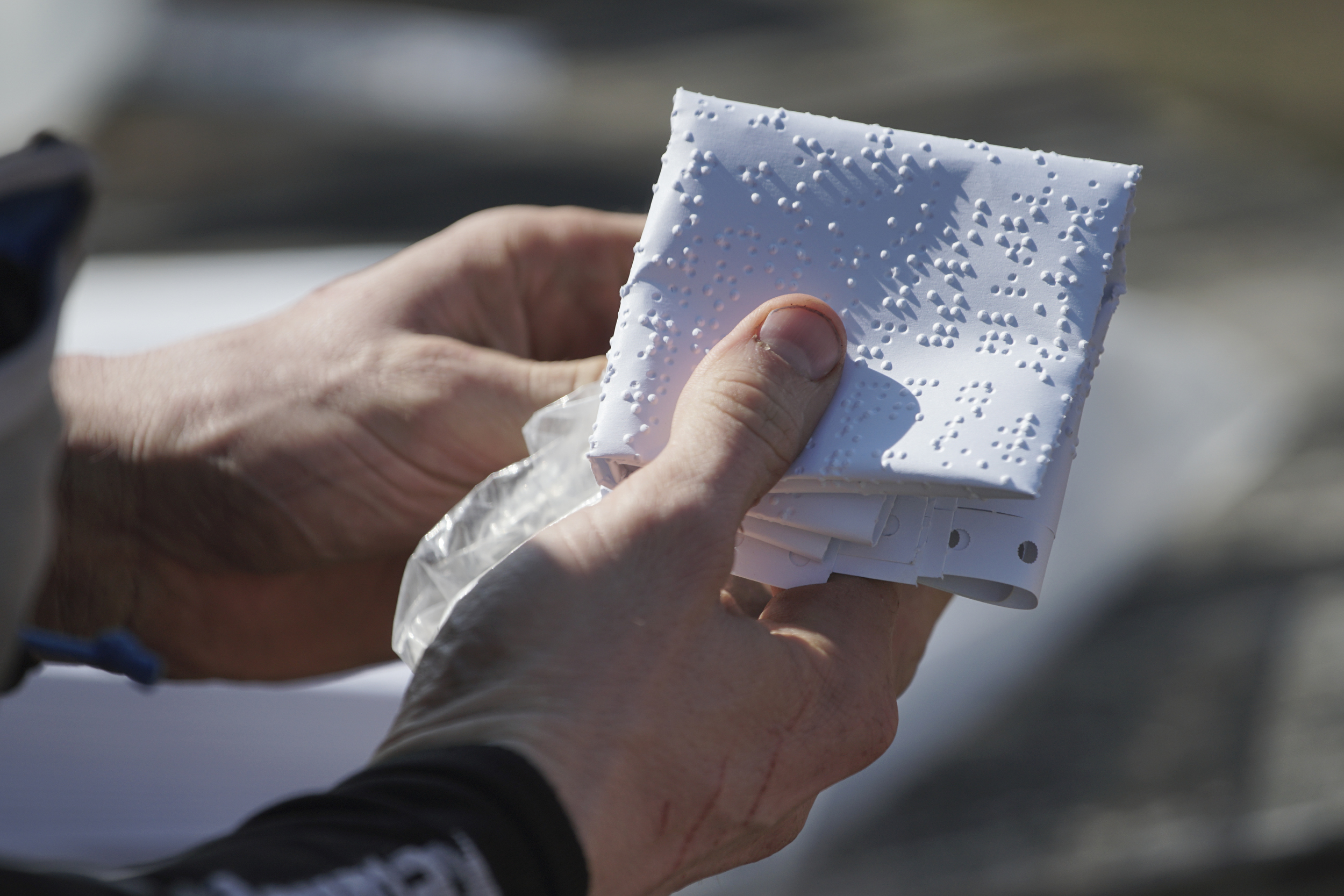 Staff Photo by Dan Henry / The Chattanooga Times Free Press- 4/4/16. Gary Robbins picks up a braille page before departing from the Frozen Head Lookout Tower on his fifth loop during the 30th running of the Barkley Marathons at Frozen Head State Park in Warburg, Tenn., on April 4, 2016. Robbins completed four and a half loops before pulling himself from the race due hallucinations from lack of sleep. The Barkley Marathons is part orienteering, part ultra marathon where a select few attempt to complete up to five 20 mile loops within a 60-hour time limit where they search for hidden book caches deep in the woods throughout the park.