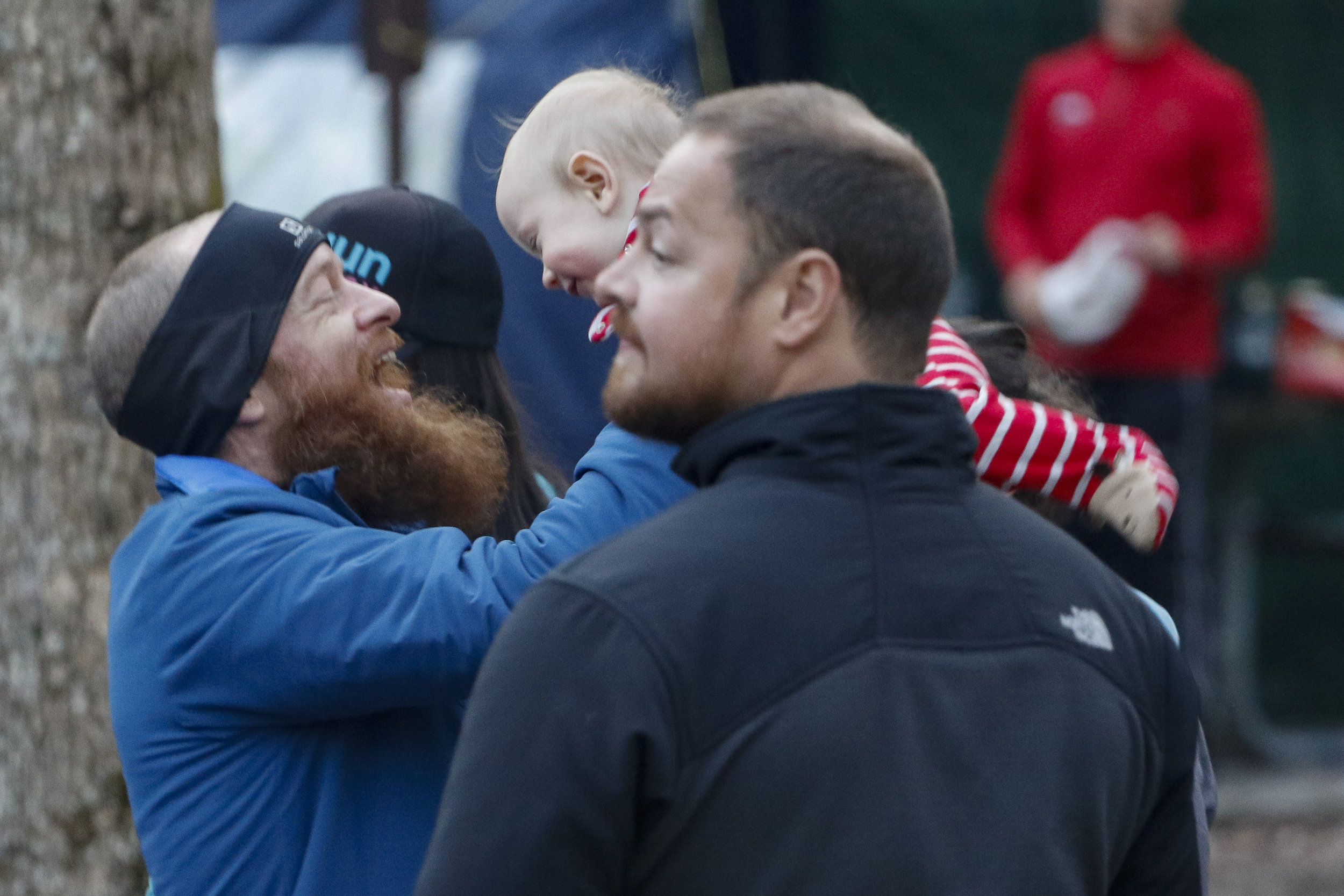 Staff Photo by Dan Henry / The Chattanooga Times Free Press- 4/4/16. Gary Robbins tosses his son Reed in the air before heading out on his fourth loop during the 30th running of the Barkley Marathons at Frozen Head State Park in Warburg, Tenn., on April 3, 2016. Robbins completed four and a half loops before pulling himself from the race due hallucinations from lack of sleep. The Barkley Marathons is part orienteering, part ultra marathon where a select few attempt to complete up to five 20 mile loops within a 60-hour time limit where they search for hidden book caches deep in the woods throughout the park.