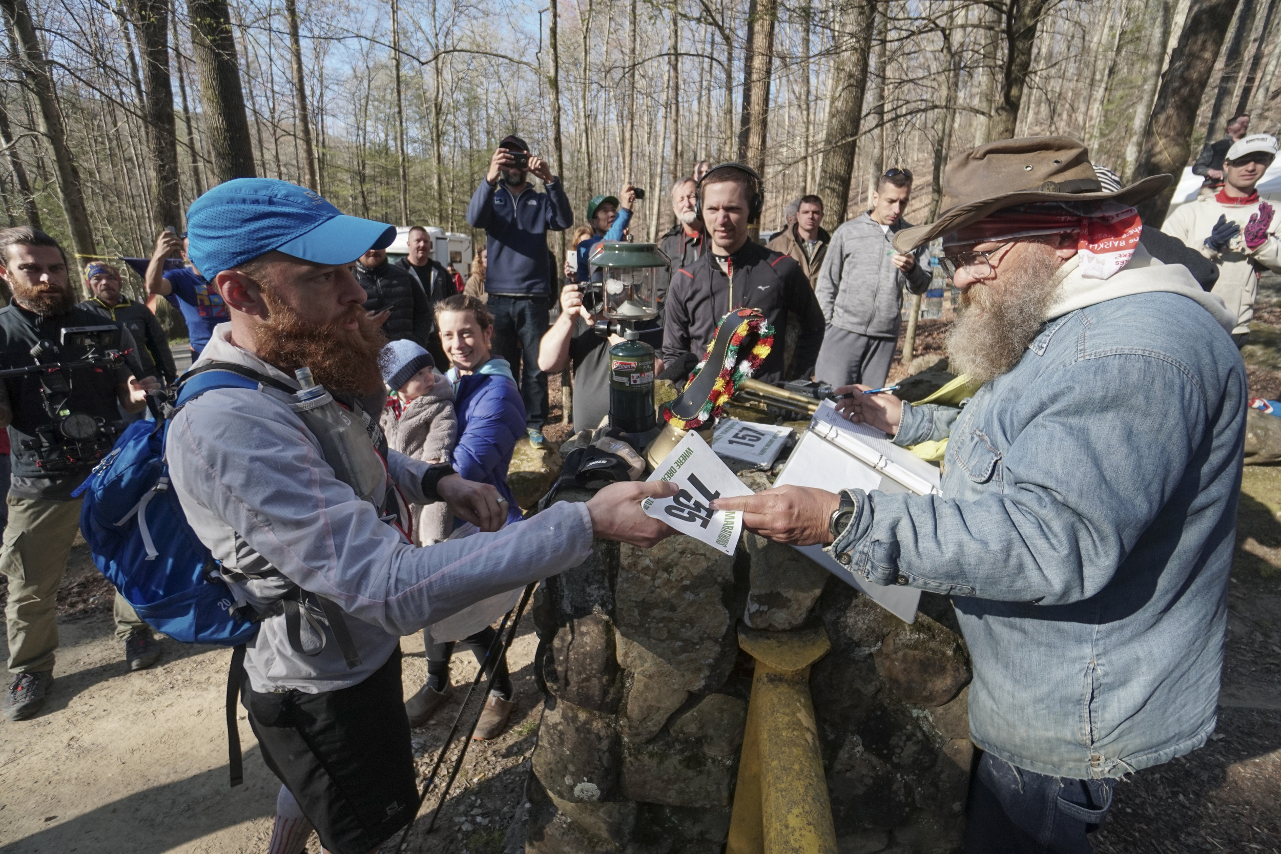 Staff Photo by Dan Henry / The Chattanooga Times Free Press- 4/4/16. Gary Robbins receives his race number from Gary ԌazՠCantrell before heading out on his fifth loop during the 30th running of the Barkley Marathons at Frozen Head State Park in Warburg, Tenn., on April 4, 2016. Robbins completed four and a half loops before pulling himself from the race due hallucinations from lack of sleep. The Barkley Marathons is part orienteering, part ultra marathon where a select few attempt to complete up to five 20 mile loops within a 60-hour time limit where they search for hidden book caches deep in the woods throughout the park.