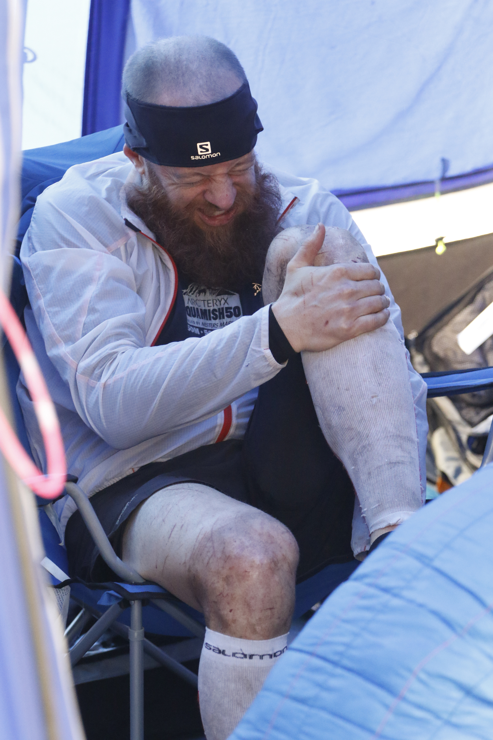Staff Photo by Dan Henry / The Chattanooga Times Free Press- 4/3/16. Gary Robbins winces in pain as he swaps out socks before heading out on his fifth loop during the 30th running of the Barkley Marathons at Frozen Head State Park in Warburg, Tenn., on April 4, 2016. Robbins completed four and a half loops before pulling himself from the race due hallucinations from lack of sleep. The Barkley Marathons is part orienteering, part ultra marathon where a select few attempt to complete up to five 20 mile loops within a 60-hour time limit where they search for hidden book caches deep in the woods throughout the park.