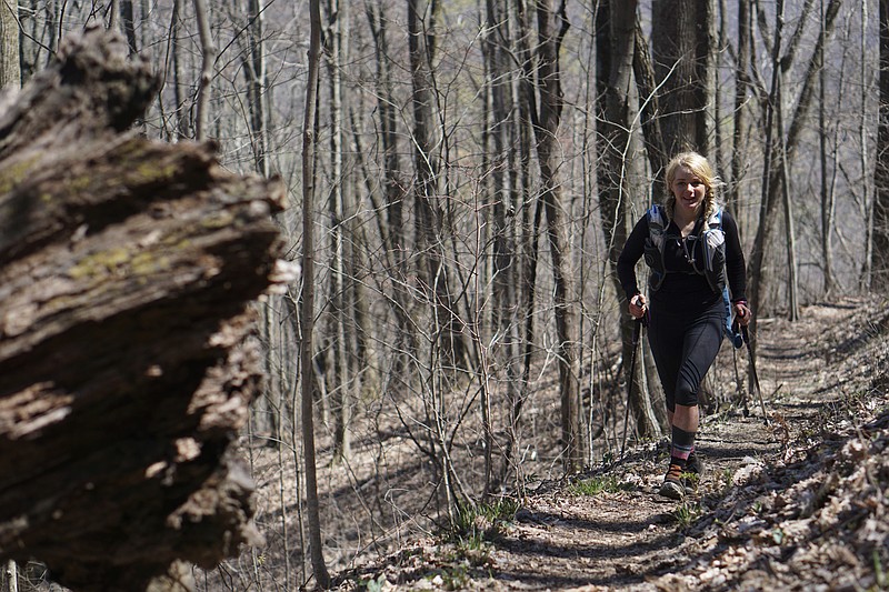 Staff Photo by Dan Henry / The Chattanooga Times Free Press- 4/3/16. Jennilyn Eaton from Salt Lake City makes her way down the Chimney Top Trail on her second loop during the 30th running of the Barkley Marathons at Frozen Head State Park in Warburg, Tenn., on April 3, 2016. Jennilyn was the only female to start a third loop at the 2016 Barkley. The Barkley Marathons is in its 30th year and consists of part orienteering and part ultra marathon where a select few attempt to complete five 20 mile loops within a 60-hour time limit where they search for hidden book caches deep in the woods throughout the park. 