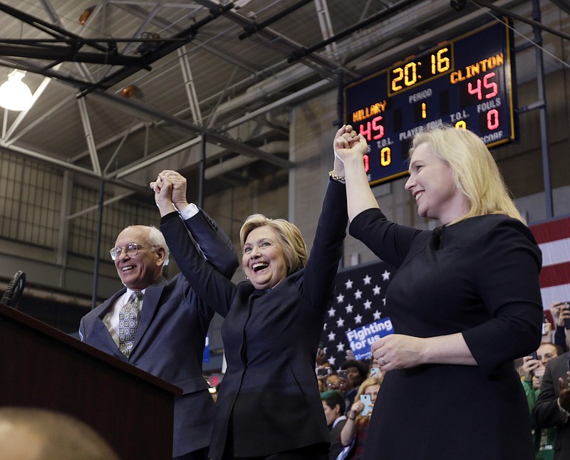 Democratic presidential candidate Hillary Clinton, center, stands with Rep. Paul Tonko, D-N.Y., and Sen. Kirsten Gillibrand, D-N.Y., after speaking at a rally at Cohoes High School on Monday, April 4, 2016, in Cohoes, N.Y.