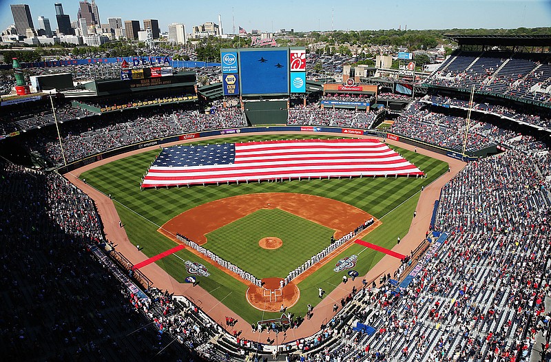 A United States flag is unfurled in the outfield for the national anthem before the final season home-opening baseball game at Turner Field between the Atlanta Braves and the Washington Nationals on Monday, April 4, 2016, in Atlanta. The Braves will move to a newly constructed stadium for next season. 