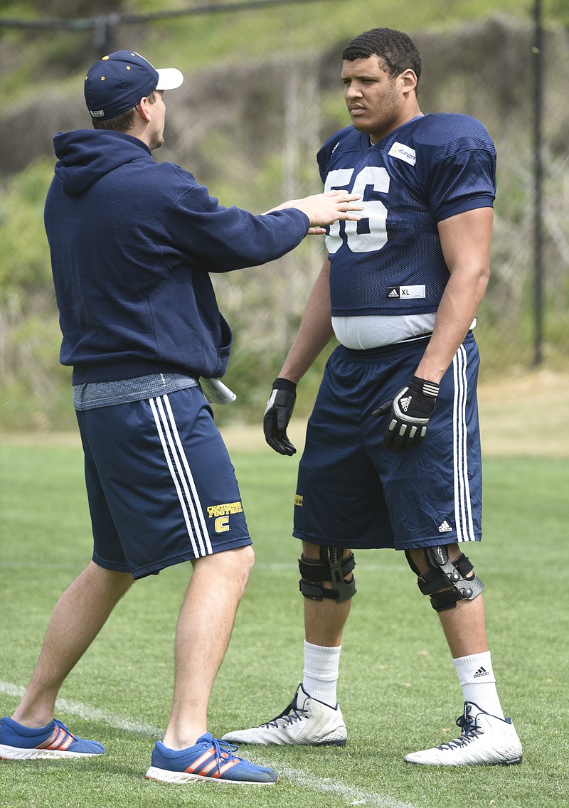 UTC offensive lineman Malcolm White listens to tight ends coach Chris Harr during practice Wednesday. White redshirted as a freshman last fall but is the top candidate to fill a vacancy on an offensive line featuring four returning starters.
