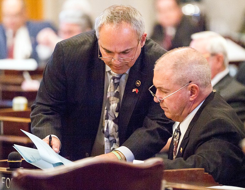 
              Reps. Tim Wirgau, R-Buchanan, left, and John Forgety, R-Athens, confer on the House floor in Nashville, Tenn., on Wednesday, April 6, 2016, during a debate about a bill to allow counselors to refuse treatment of patients based on personal beliefs. Those opposed to the bill, say the measure casts such a wide net that therapists could virtually turn anyone away. (AP Photo/Erik Schelzig)
            