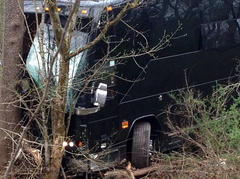 
              A tour bus for musician Gregg Allman's band rests against a tree near a creek after veering off Interstate 77 Wednesday morning, April 6, 2016, near Goldtown, W.Va. A tour spokesman for Allman's band says three crew members have been injured. The bus was headed to a concert Wednesday at the Clay Center in Charleston, about 20 miles south of Goldtown. Clay Center spokeswoman LeAnn Cain said the concert is still on. Allman wasn't on the bus.  (Brooke Thibodaux/WCHS-TV via AP) CHARLESTON (W.VA.) OUT
            