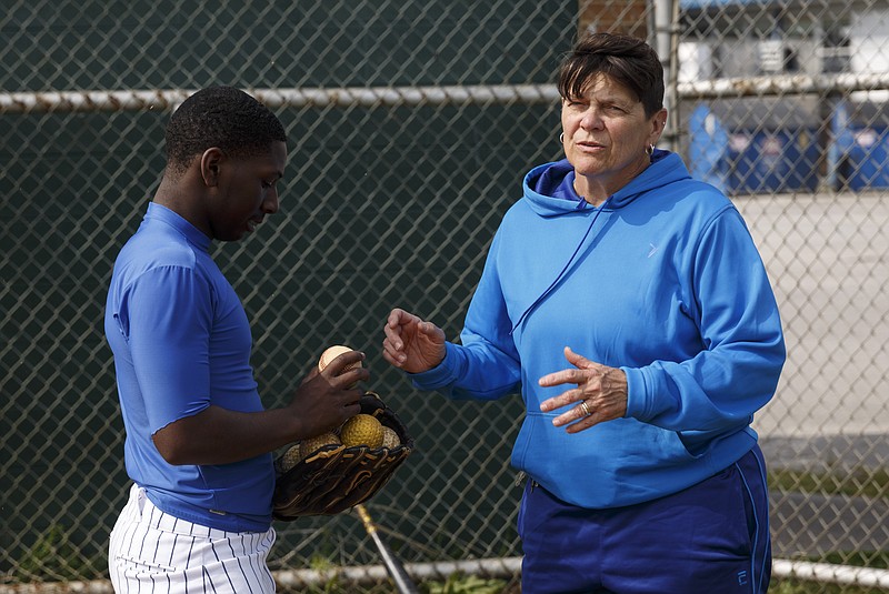 Brainerd baseball coach Jane Camp talks with player Edward Taylor during batting practice Wednesday. He says she's "like my second mom" in addition to being a good coach.