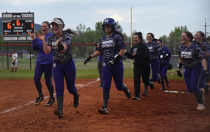 Marion County players run onto the field to celebrate a home run hit against Whitwell Thursday, April 7, 2016 at Whitwell HIgh School.