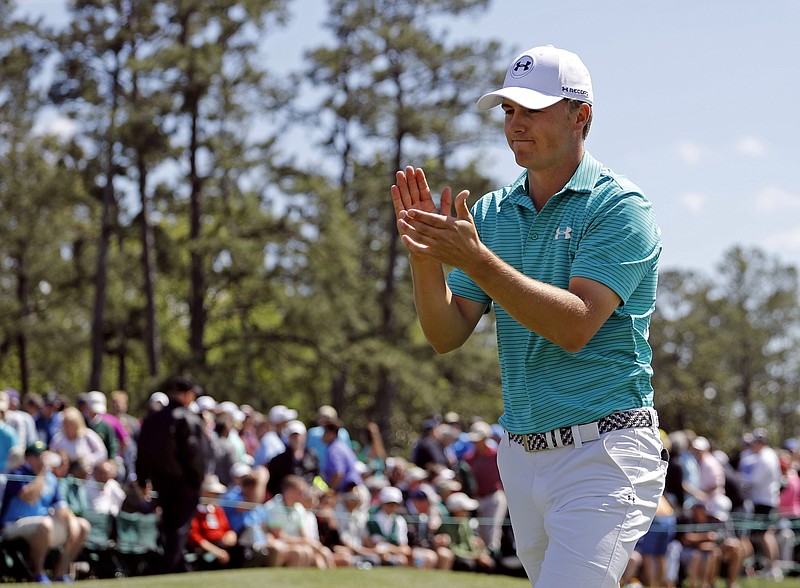 Jordan Spieth applauds on the 18th green following his first round of the Masters golf tournament Thursday, April 7, 2016, in Augusta, Ga. (AP Photo/Matt Slocum)
