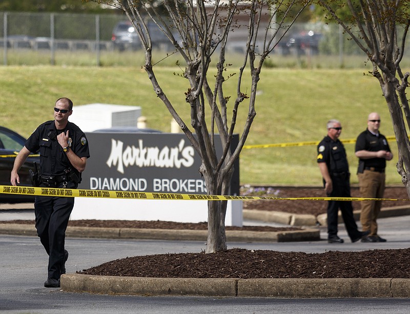 Police stand at the scene after an attempted robbery at Markman's jewelry store at Hamilton Place Mall on Friday, April 8, 2016, in Chattanooga, Tenn.
