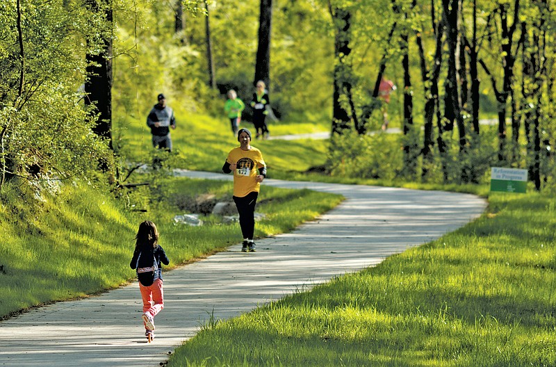 Competitors run in the South Chick Sunriser 5k race at the grand opening celebration day of the South Chickamauga Creek Greenway on Saturday, April 9, 2016, in Chattanooga, Tenn. The greenway connects to the Tennessee Riverpark near Amnicola highway.